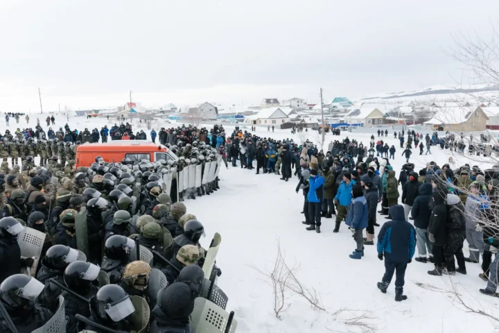 Riot policemen disperse protesters in the town of Baymak