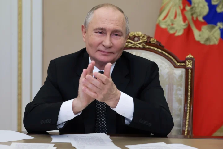 Russian President Vladimir Putin applauds
