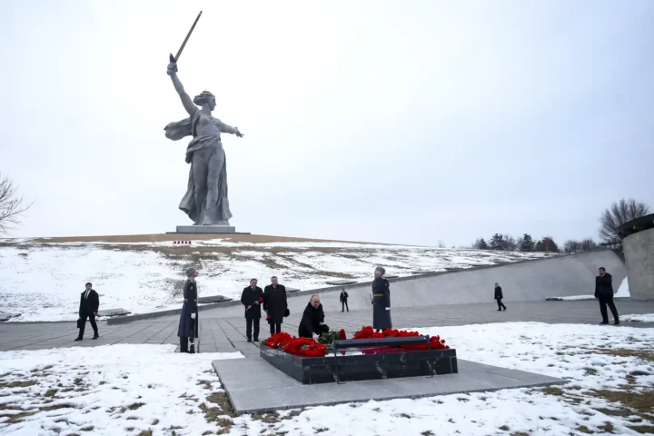 Russian President Vladimir Putin lays flowers at the memorial