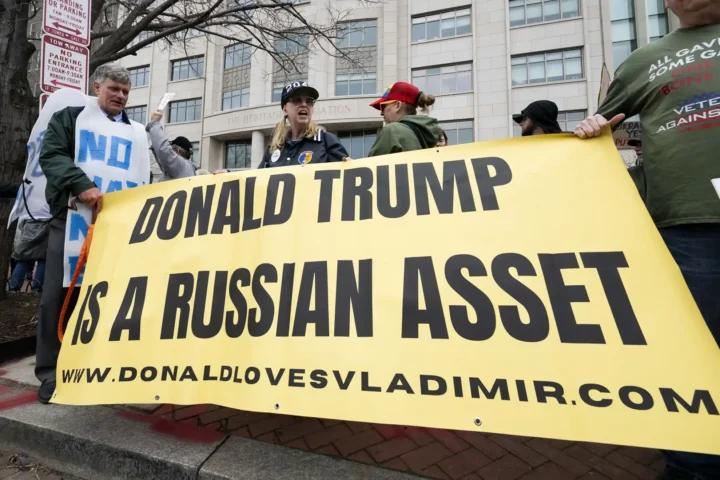 People with a banner saying ''Donald Trump is a Russian asset''