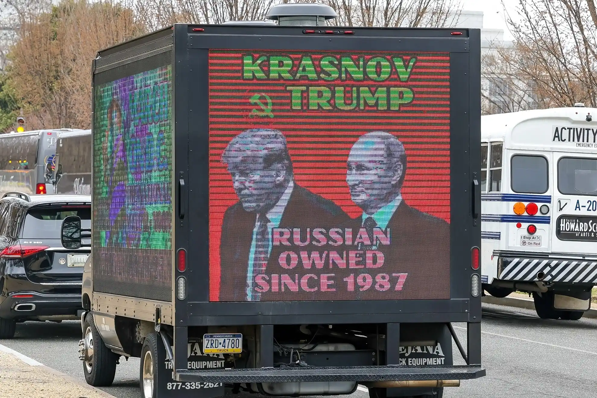 An advertising truck displaying images of President Trump and Russian President Putin
