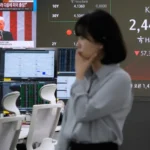 a currency trader works at the foreign exchange dealing room of the KEB Hana Bank