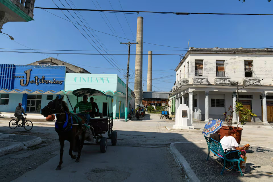 People ride in a horse-drawn carriage