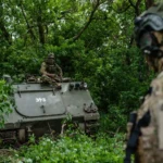 Ukrainian soldiers and armored vehicles