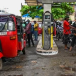 An employee fills a motorcycle