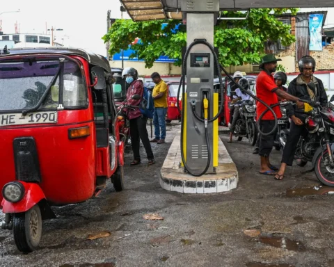 An employee fills a motorcycle